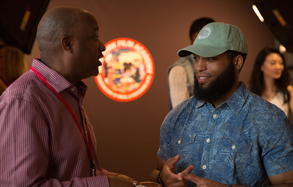 two people talking at the 2016 nyfa fall film commencement ceremony