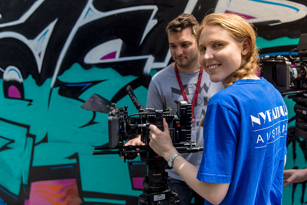 female nyfa student with camera