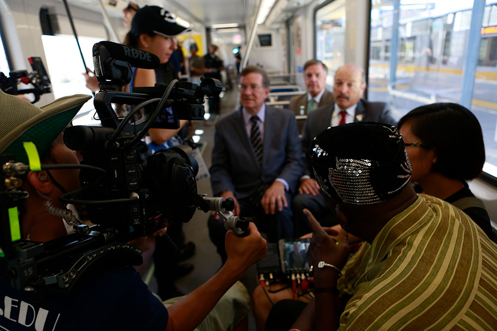 group filming people on train