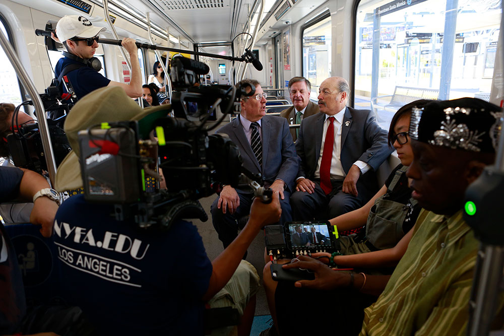 two people being filmed on a train