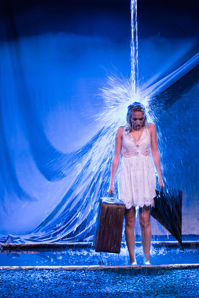 NYFA musical theatre student under downpour of water onstage in Eurydice.